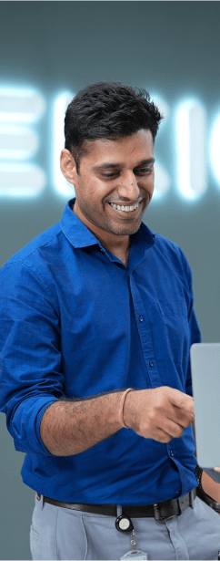 Tekion employee pointing at a computer screen, demonstrating the capabilities of Tekion’s Automotive Retail Cloud